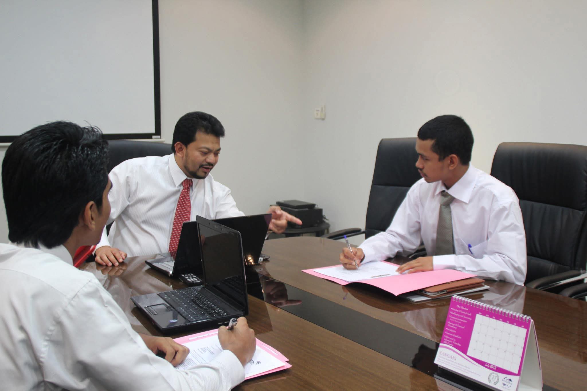 The team reviewing case files together in the firm's boardroom.