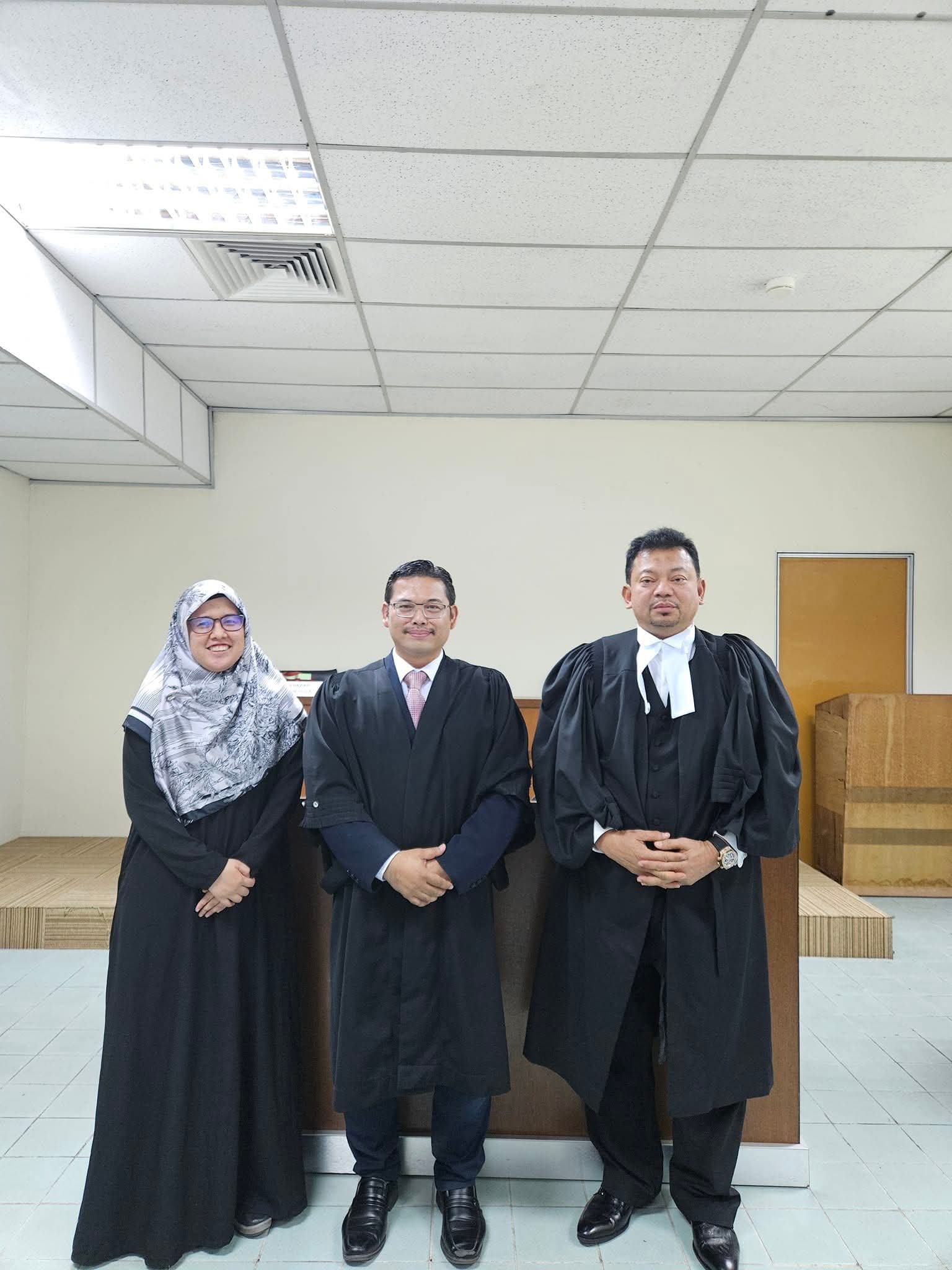 Members of the firm in court robes inside a courtroom.